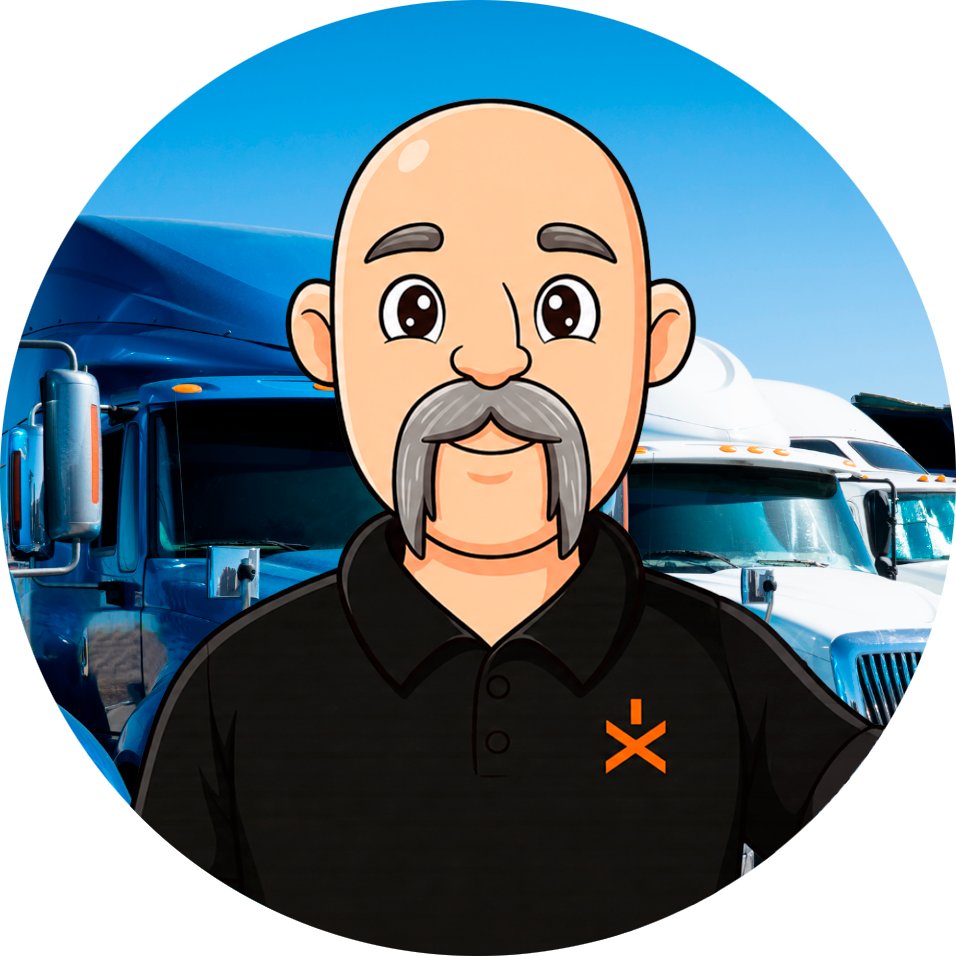 Cartoon mascot of a smiling, bald man with a gray mustache wearing a black polo, standing in front of blue semi-trucks in a truck yard